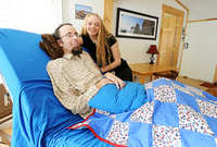 Nicholas Stanley, 32, of Farmington is a quadriplegic due to spinal muscular atrophy, a condition brought on by a congenital defect known as a tethered spinal cord. He has been ingesting medical marijuana since 2003 to relieve his pain, anxiety and depression. Patricia Soderholm, right, his longtime caregiver, has become frustrated over Stanley's difficulty in obtaining a certificate for medical marijuana under the state's new system.- Amber Waterman/Sun Journal